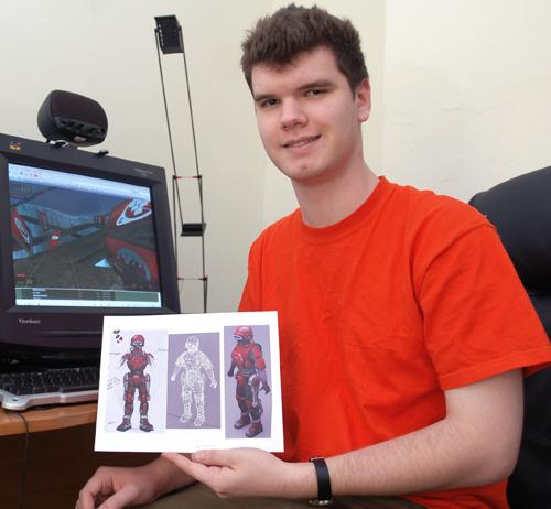 William Smith, junior in LAS, holds snapshots of his work that he does as a volunteer for the SourceForts modification game for the website www.sourcefortsmod.com in his apartment, Oct 31, 2006. Will creates 3D players by making a 3D mesh and skeleton fro Dan Hollander The Daily Illini
